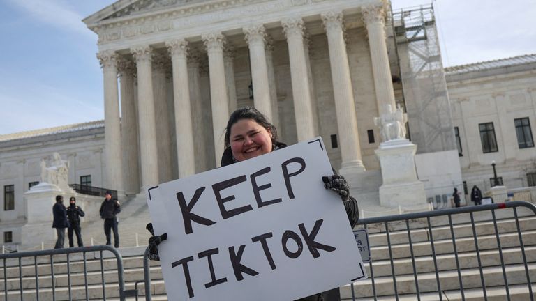 A person holds a placard on the day justices hear oral arguments in a bid by TikTok and its China-based parent company, ByteDance, to block a law intended to force the sale of the short-video app by Jan. 19 or face a ban on national security grounds, outside the U.S. Supreme Court, in Washington, U.S., January 10, 2025. REUTERS/Marko Djurica