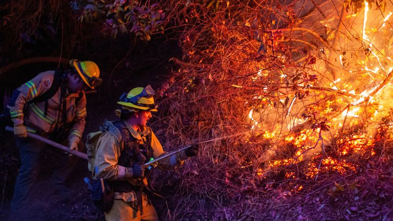 Firefighters battle the Palisades fire. Pic: Reuters