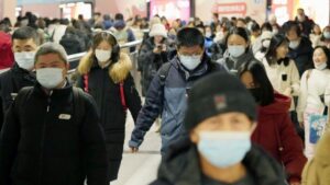 People walk in Beijing on 6 January. Pic: AP/Kyodo