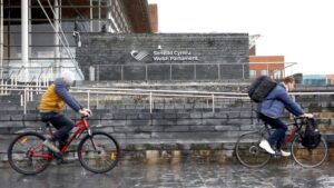 People cycle past The Senedd (Welsh parliament) building in Cardiff.
Pic: Reuters